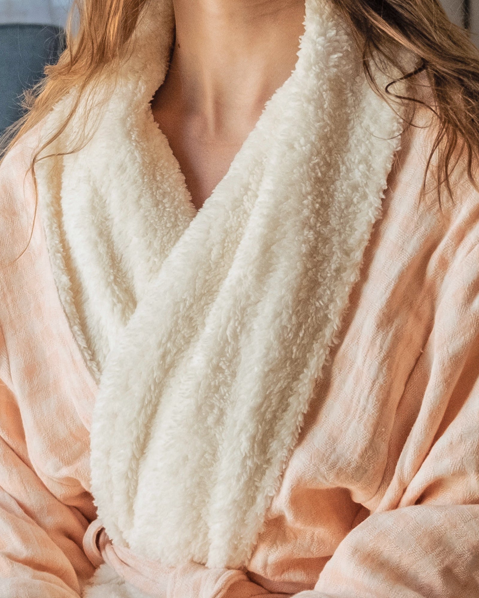 Coral checkered robe with white fleece lining worn by a young woman