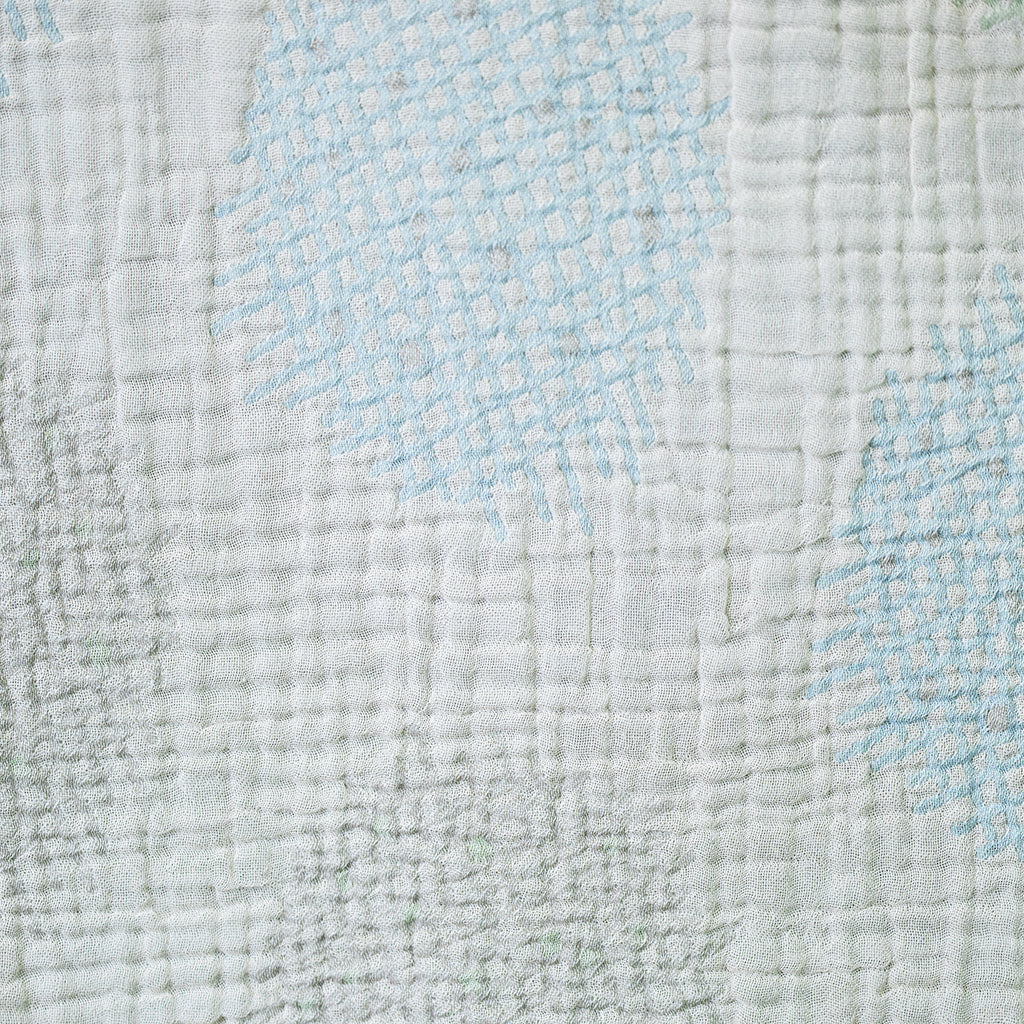 Close-up of textured fabric with blue cross hatch patterns