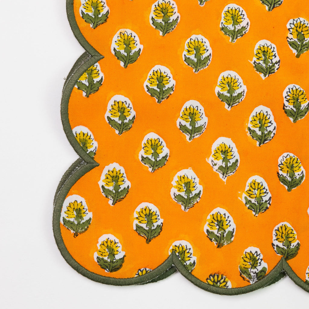 Decorative orange mat with floral patterns on a white background