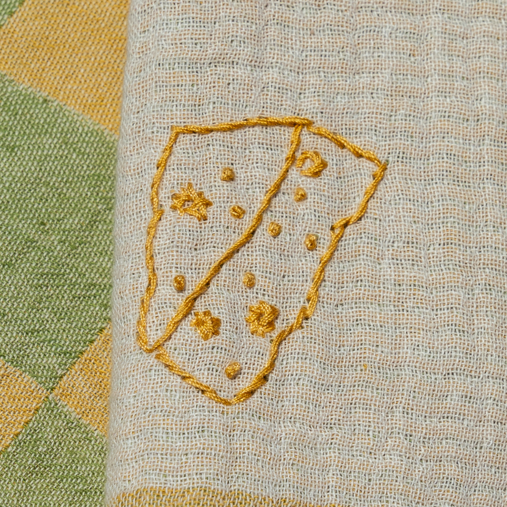 Close-up of embroidered design on fabric with a geometric pattern