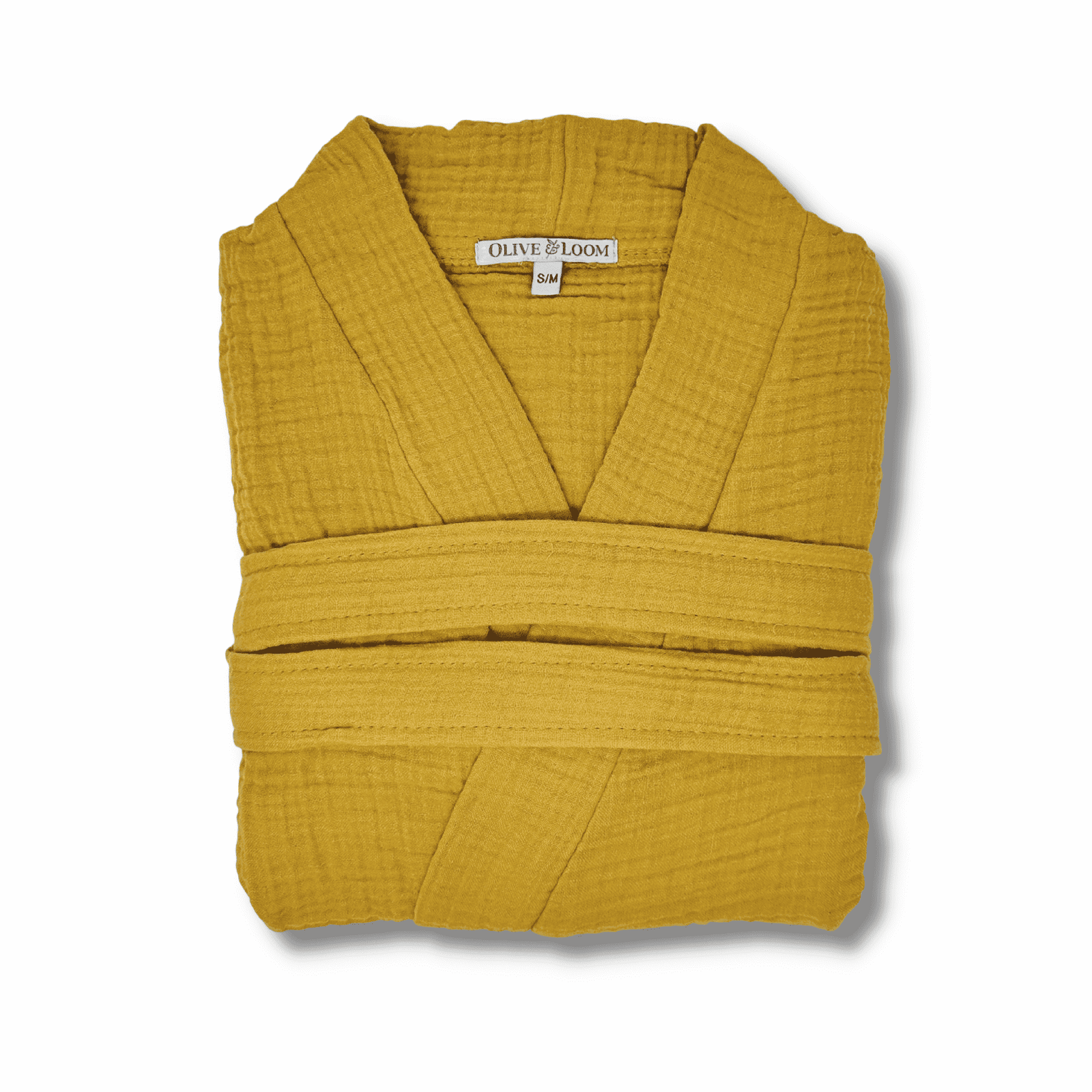 Mustard colored muslin cotton spa robe folded on a white background
