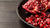 Pomegranate seeds on a dark surface