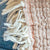 Close-up of a textured fabric with fringes and a ribbed pattern.