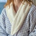 Blue checkered robe with white fleece lining worn by a young woman