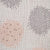 Close-up of textured fabric with geometric patterns in gray, pink, and white.