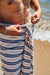 Person wearing striped Turkish Towel on a beach