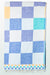 Checkered towel with blue, white, and yellow squares on a white background