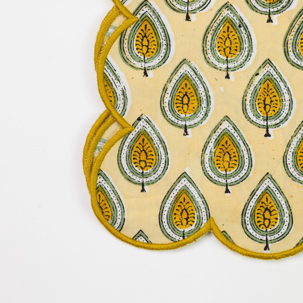 Set of coasters with a yellow and green pattern on a beige background