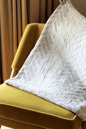 Animated image of a throw blanket tossed over a chair