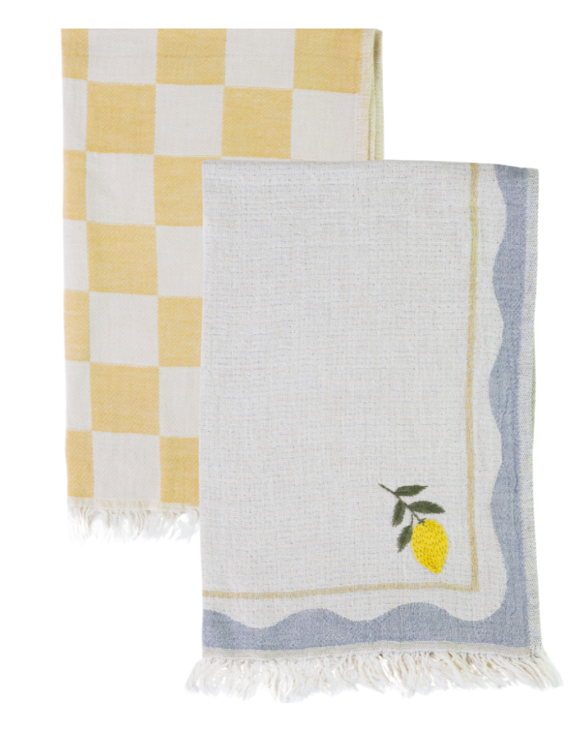 Two kitchen towels, one checkered yellow and white, the other with a lemon design, on a white background.