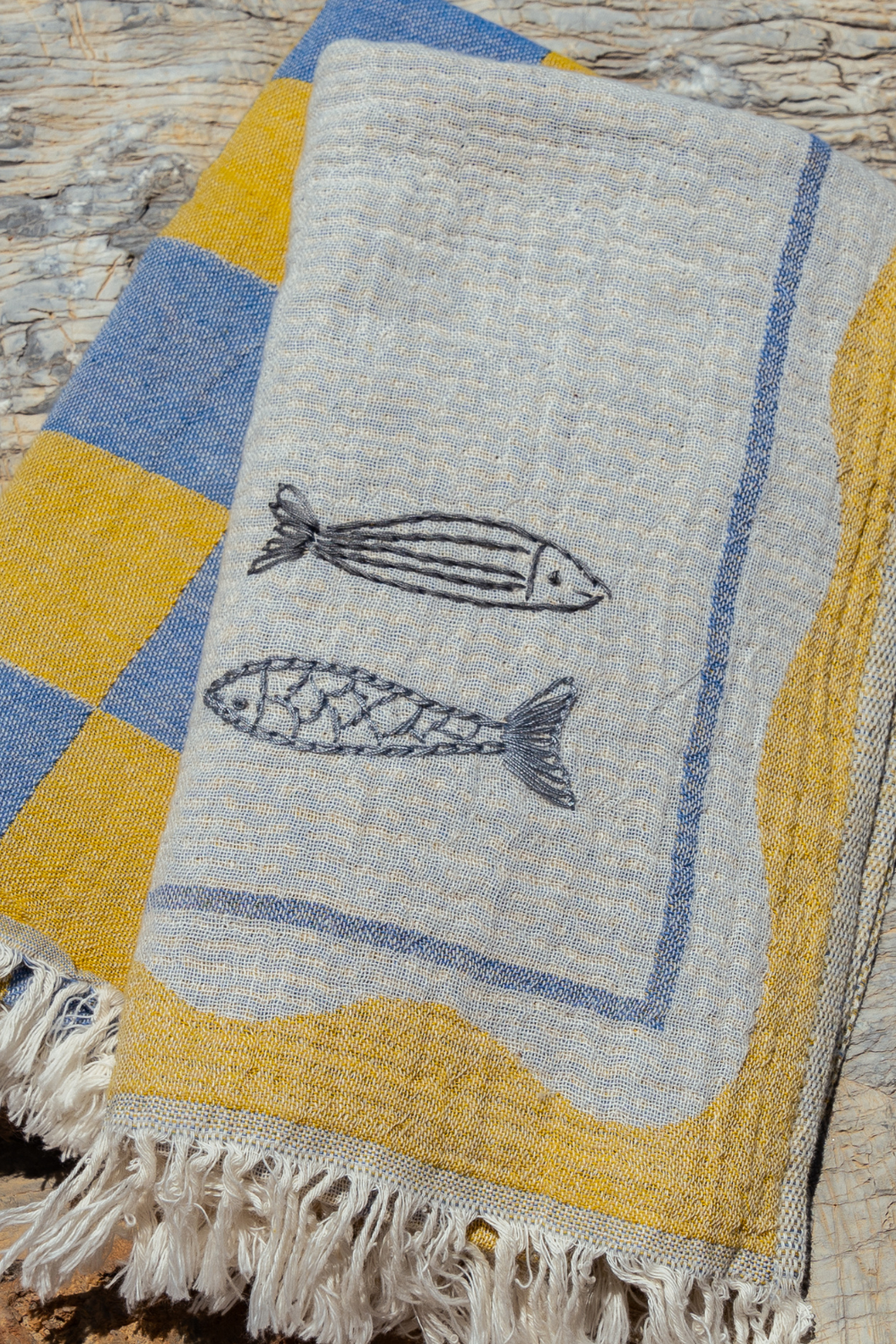 Textile with fish design on a stone surface