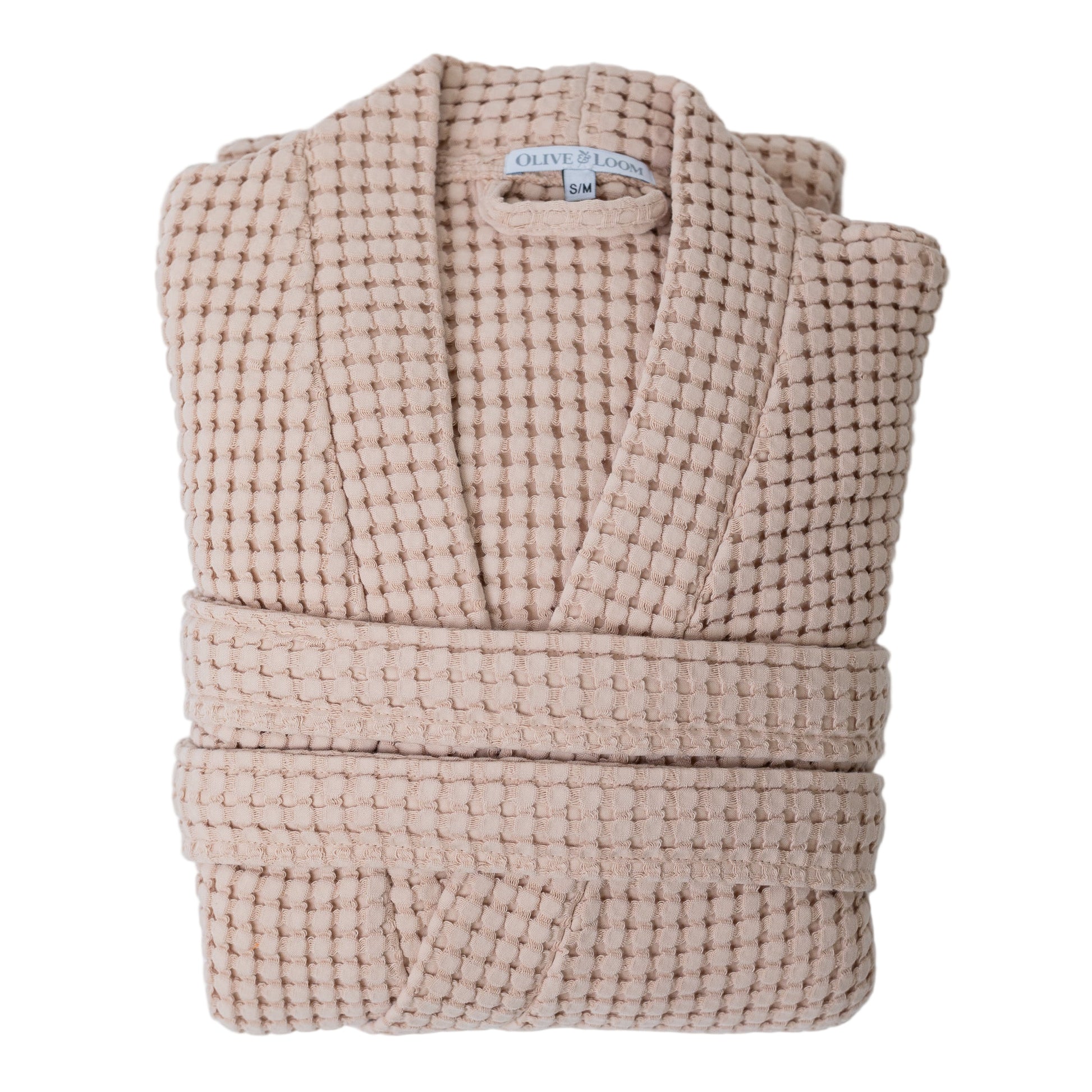 Folded waffle robe in tea rose against a white background
