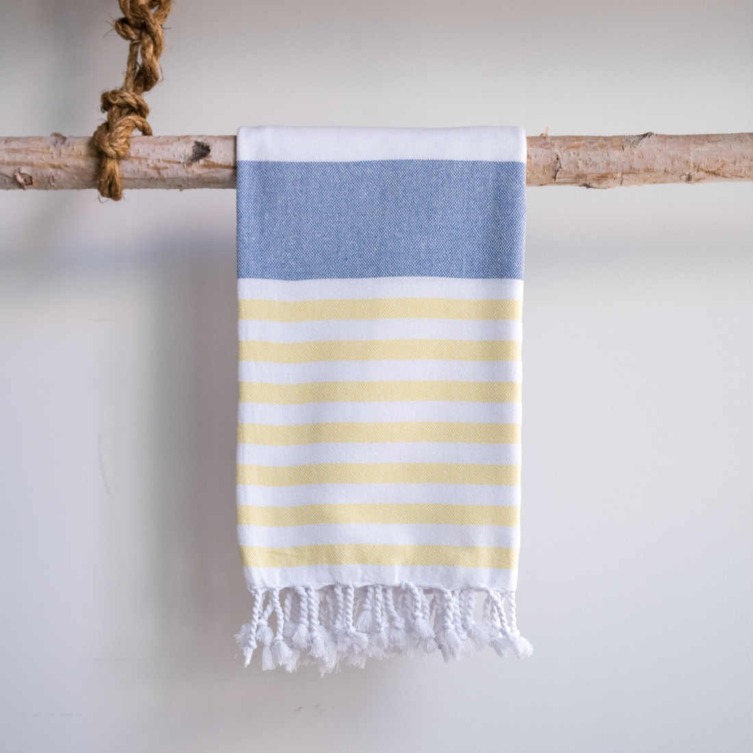 Three Marine Turkish Towels hanging on a display rod