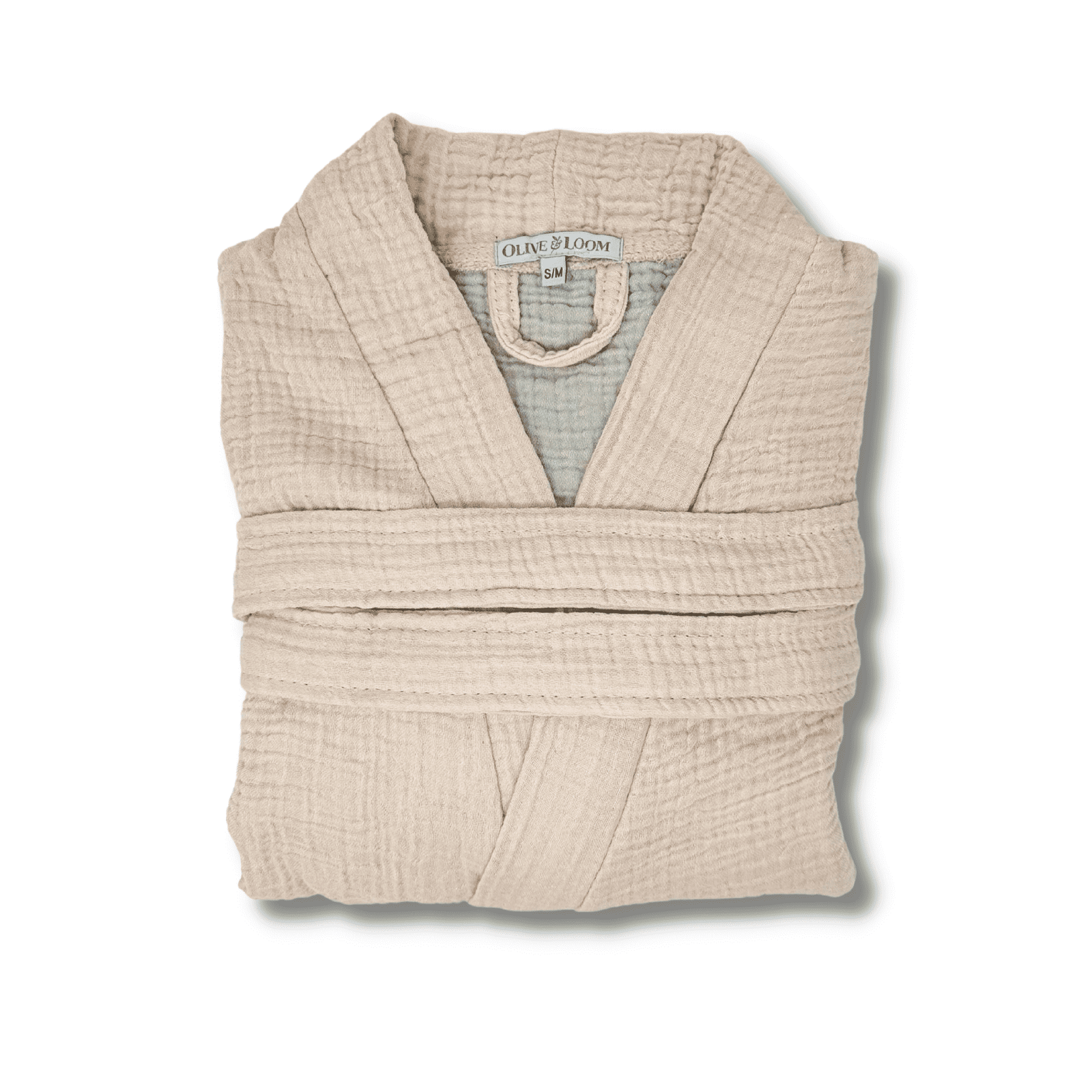 blush colored muslin cotton spa robe folded on a white background