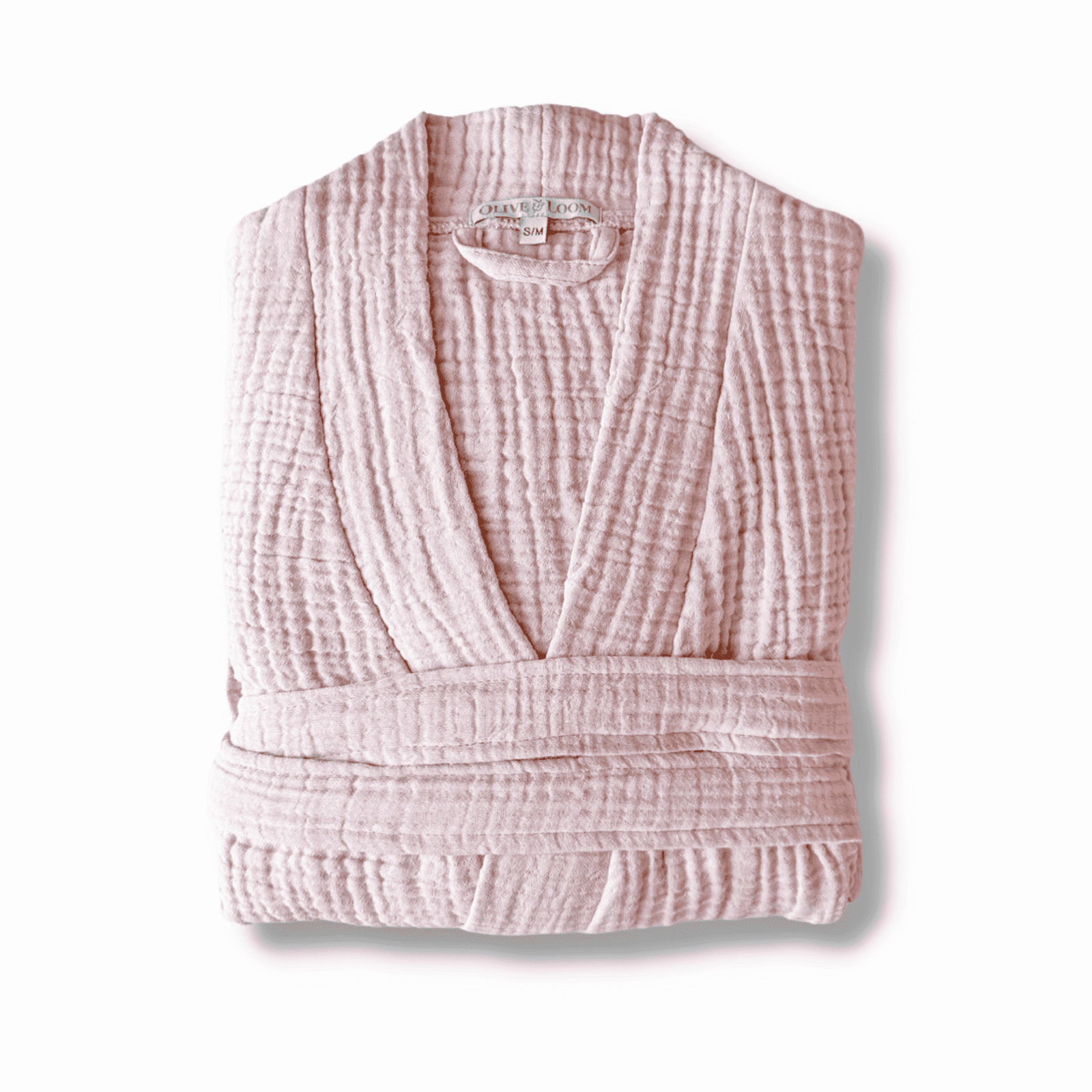 Lilac colored muslin cotton spa robe folded on a white background