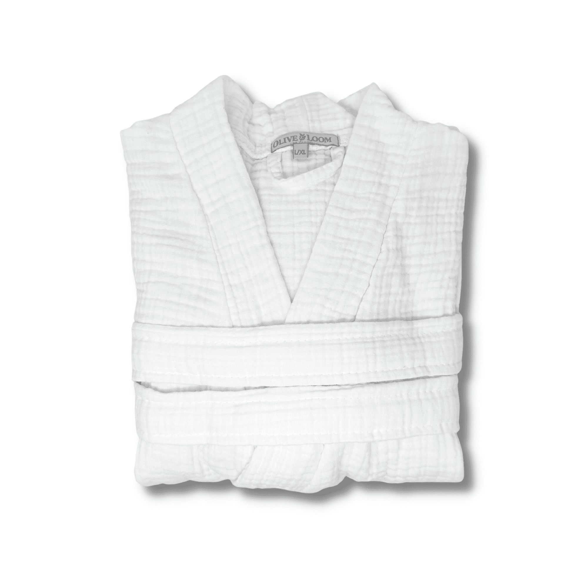 White muslin cotton spa robe folded on a white background